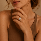 Claire engagement ring worn on a model's hand, resting against the chin