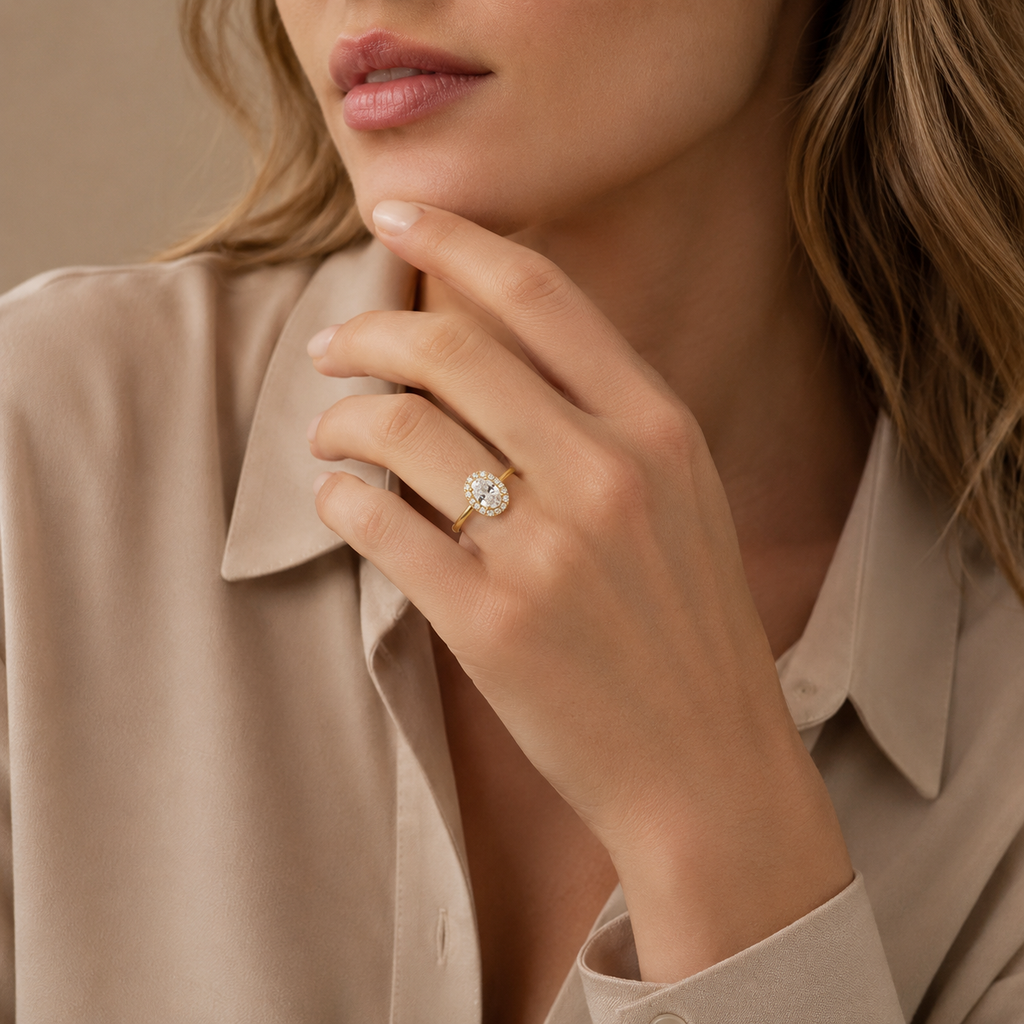 Eleanor halo engagement ring worn on a model's hand resting beneath the chin