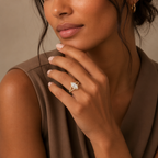 Model wearing the Juliette marquise halo ring in yellow gold, hand raised to the chin