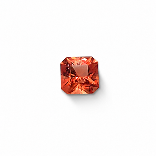 Oregon sunstone in a square radiant cut, warm orange-red, on a white background