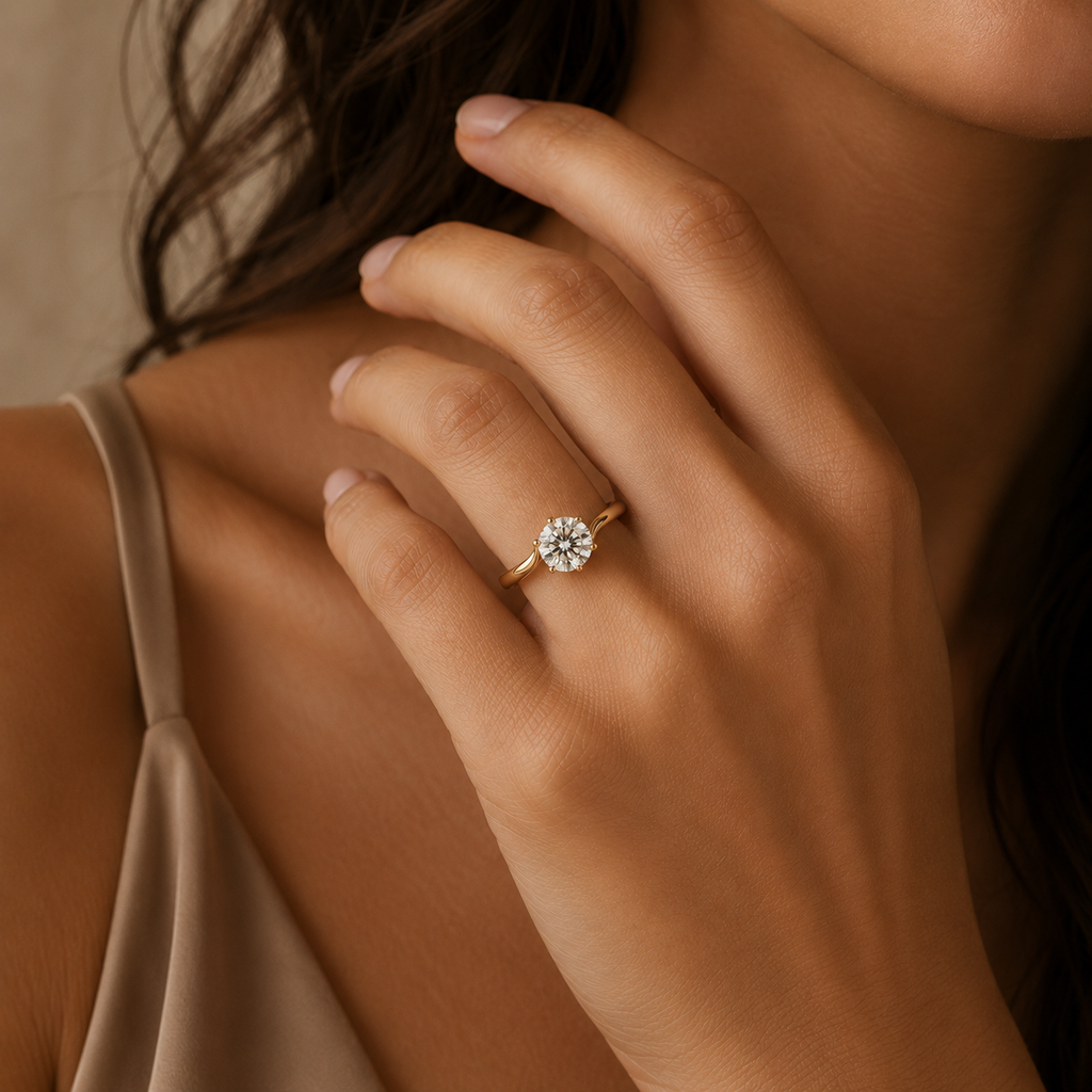 Model wearing the Solara solitaire engagement ring, hand raised near the collarbone