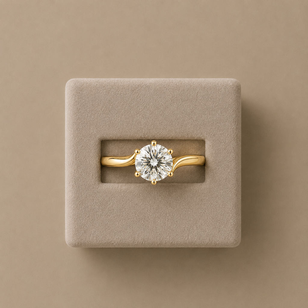 Solara solitaire ring seated in a beige suede presentation box against a taupe background